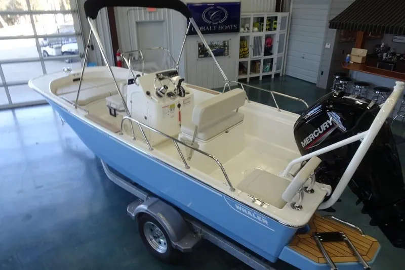 Slide: The Image of 2026 Boston Whaler 170 Montauk boat with Mercury engine in showroom. - 10