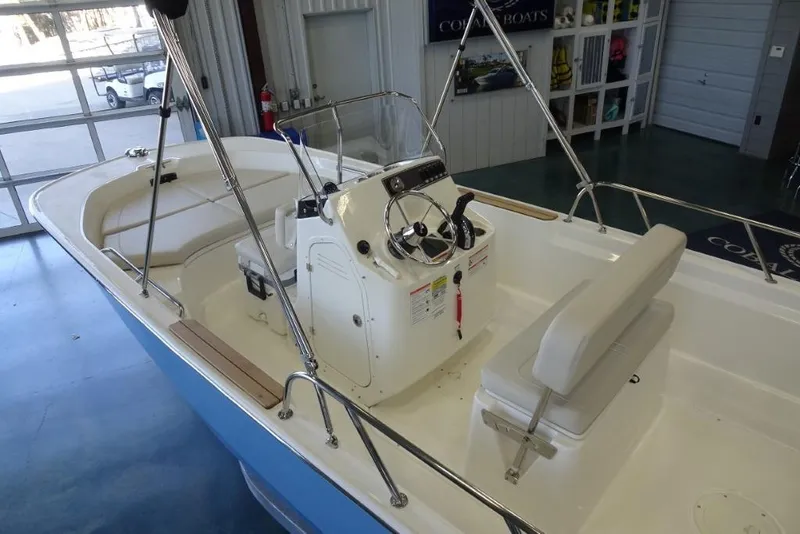 Slide: The Image of 2026 Boston Whaler 170 Montauk boat interior with steering console and seating. - 11