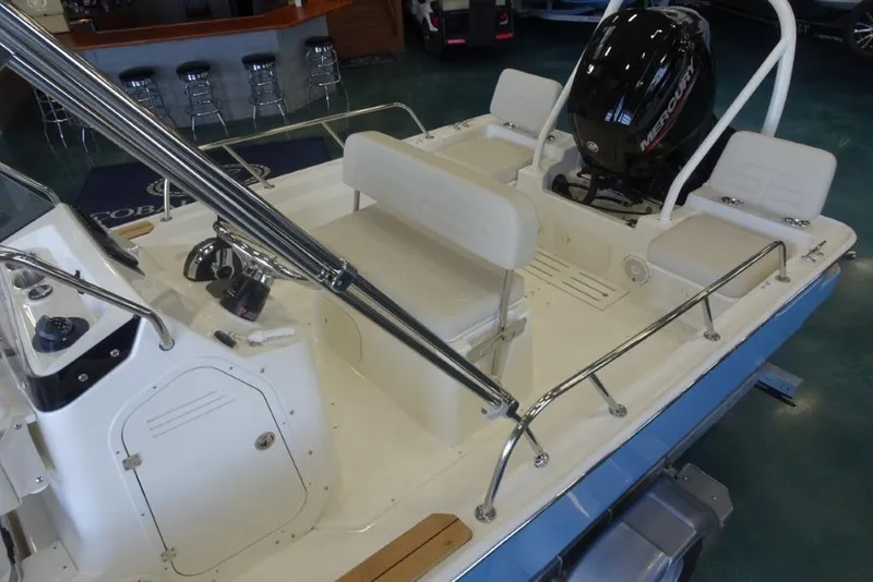 Slide: The Image of 2026 Boston Whaler 170 Montauk boat interior with seating and Mercury outboard motor. - 13