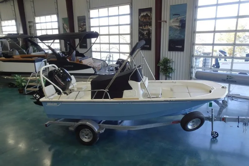 Slide: The Image of 2026 Boston Whaler 170 Montauk boat displayed in showroom on trailer. - 17