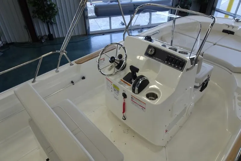 Slide: The Image of 2026 Boston Whaler 170 Montauk boat interior with steering console and seating. - 5