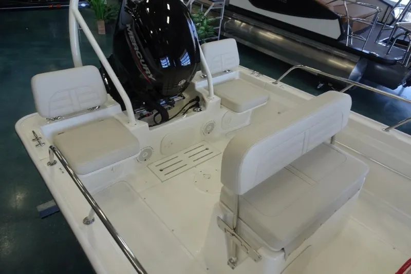 Slide: The Image of 2026 Boston Whaler 170 Montauk boat interior with seating and Mercury engine. - 6