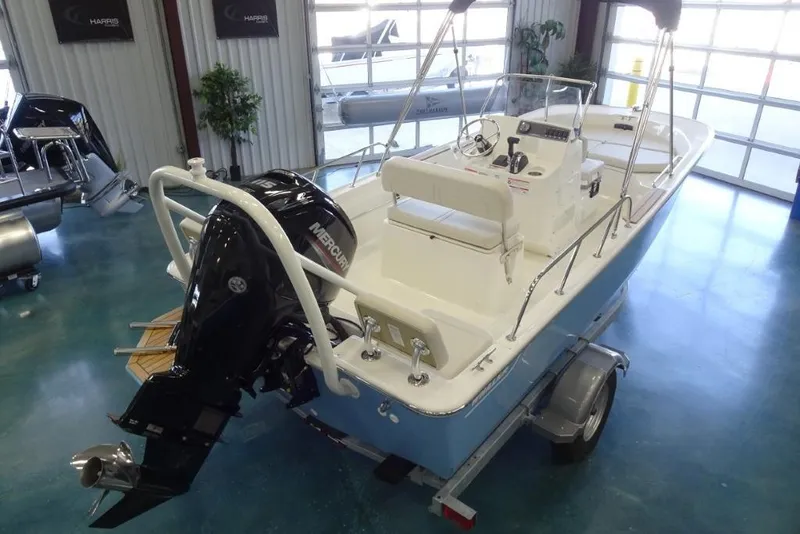 Slide: The Image of 2026 Boston Whaler 170 Montauk boat with Mercury engine in showroom. - 7