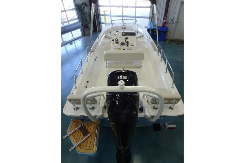 Slide: The Image of 2026 Boston Whaler 170 Montauk boat with outboard motor in showroom. - 8
