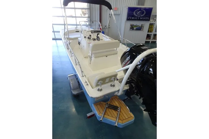 Slide: The Image of 2026 Boston Whaler 170 Montauk boat with Mercury engine in showroom. - 9