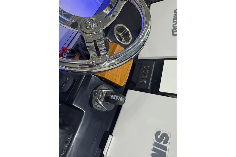 Slide: The Image of Steering wheel and controls of 2026 Robalo R300 Center Console boat. - 17