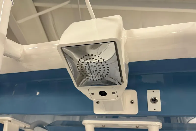 Slide: The Image of 2026 Robalo R300 Center Console boat with mounted speaker and light fixture. - 22