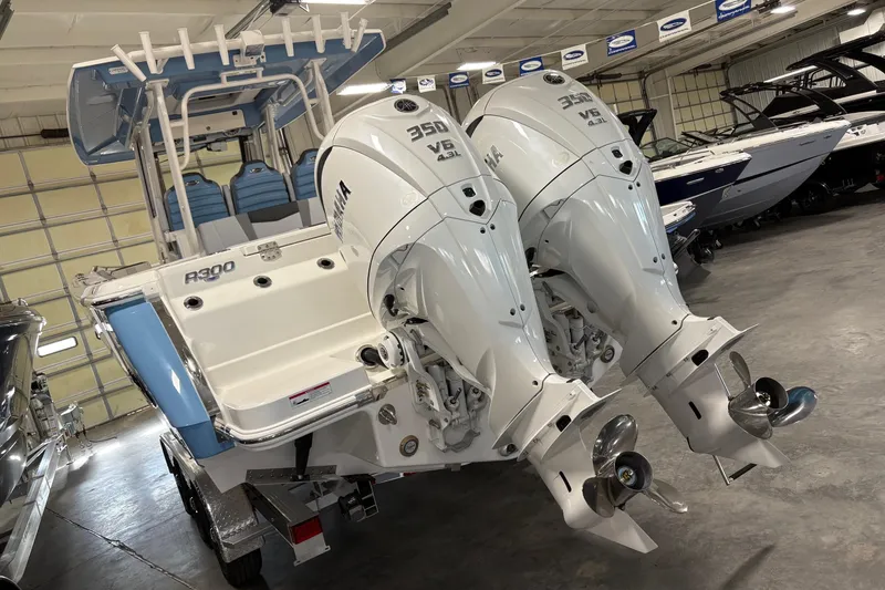 Slide: The Image of 2026 Robalo R300 Center Console boat with dual Yamaha 350 V6 engines in showroom. - 23
