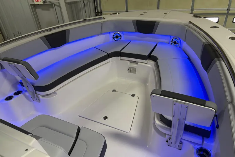Slide: The Image of 2026 Robalo R300 Center Console boat interior with blue LED lighting and cushioned seating. - 3