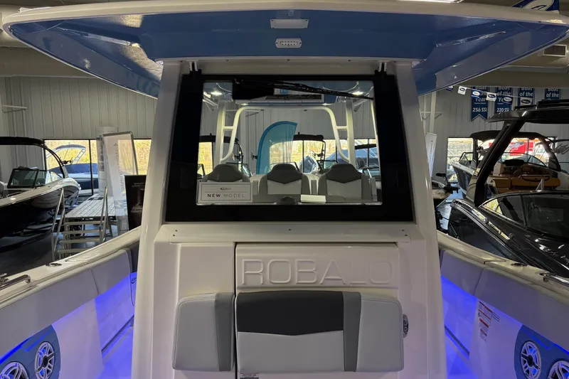 Slide: The Image of 2026 Robalo R300 Center Console boat interior with modern seating and blue LED lighting. - 5