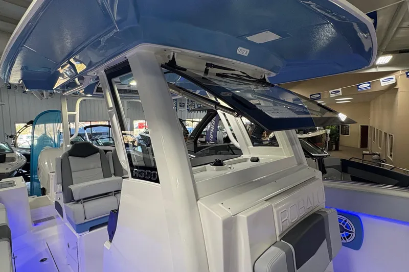 Slide: The Image of 2026 Robalo R300 Center Console boat interior with modern seating and blue accents. - 6