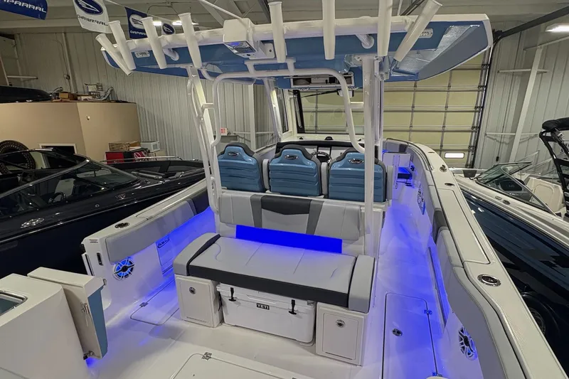 Slide: The Image of 2026 Robalo R300 Center Console boat interior with blue LED lighting and seating. - 8