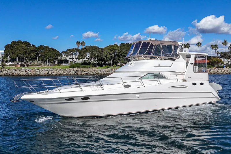 The Image of 1998 Sea Ray 420 Aft Cabin yacht cruising on a sunny day. - 1