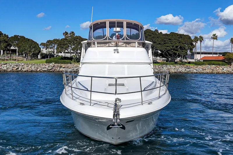 Slide: The Image of 1998 Sea Ray 420 Aft Cabin yacht cruising on a sunny day, with clear blue skies. - 11