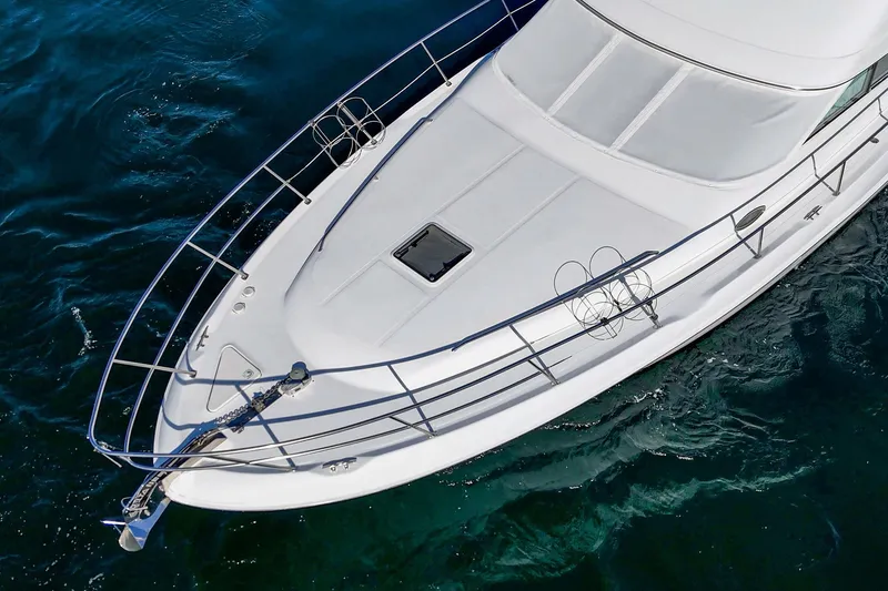 Slide: The Image of 1998 Sea Ray 420 Aft Cabin yacht on clear blue water, aerial view. - 12