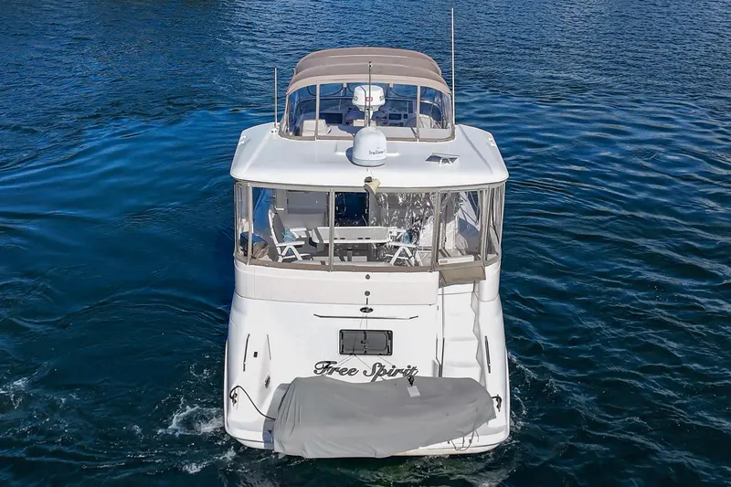 Slide: The Image of 1998 Sea Ray 420 Aft Cabin yacht on blue water, rear view. - 13