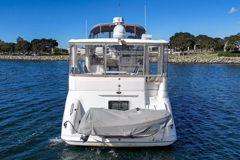 Slide: The Image of 1998 Sea Ray 420 Aft Cabin yacht on water, rear view, clear sky. - 14