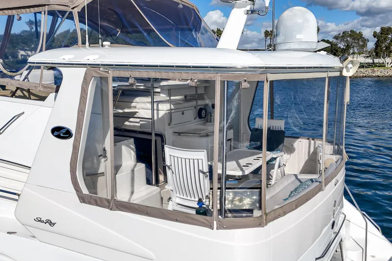 Slide: The Image of 1998 Sea Ray 420 Aft Cabin yacht with enclosed deck, docked by the water. - 15