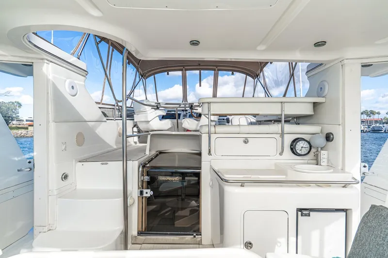 Slide: The Image of 1998 Sea Ray 420 Aft Cabin yacht interior with helm, seating, and ocean view. - 20