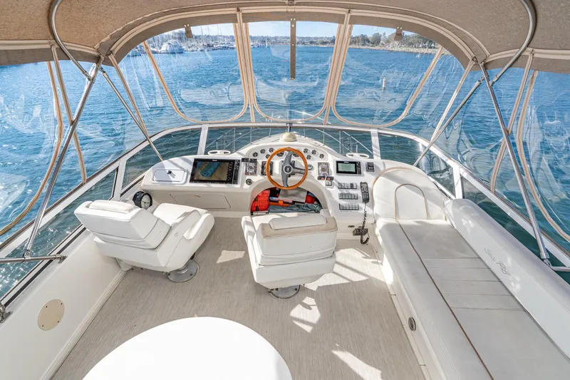 Slide: The Image of 1998 Sea Ray 420 Aft Cabin yacht helm with panoramic water views. - 23