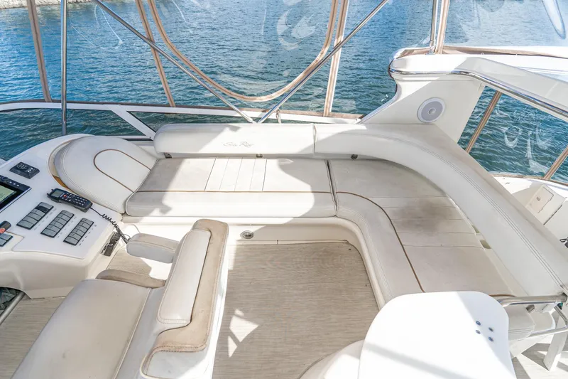 Slide: The Image of 1998 Sea Ray 420 Aft Cabin yacht interior with white seating and control panel. - 27