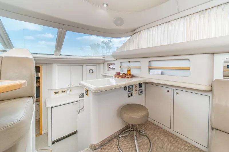 Slide: The Image of 1998 Sea Ray 420 Aft Cabin interior with modern kitchen and seating area. - 34