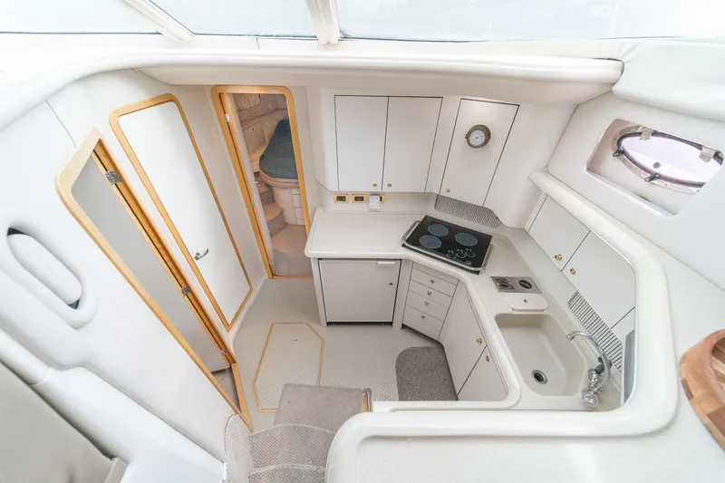 Slide: The Image of 1998 Sea Ray 420 Aft Cabin yacht interior with modern kitchen and cozy sleeping area. - 35