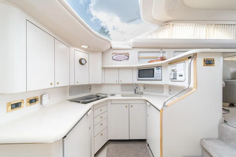 Slide: The Image of Luxurious 1998 Sea Ray 420 Aft Cabin yacht kitchen with modern appliances and sleek design. - 37