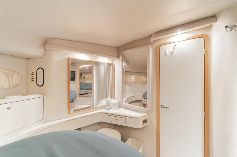 Slide: The Image of 1998 Sea Ray 420 Aft Cabin interior with mirrors, cabinets, and soft lighting. - 42