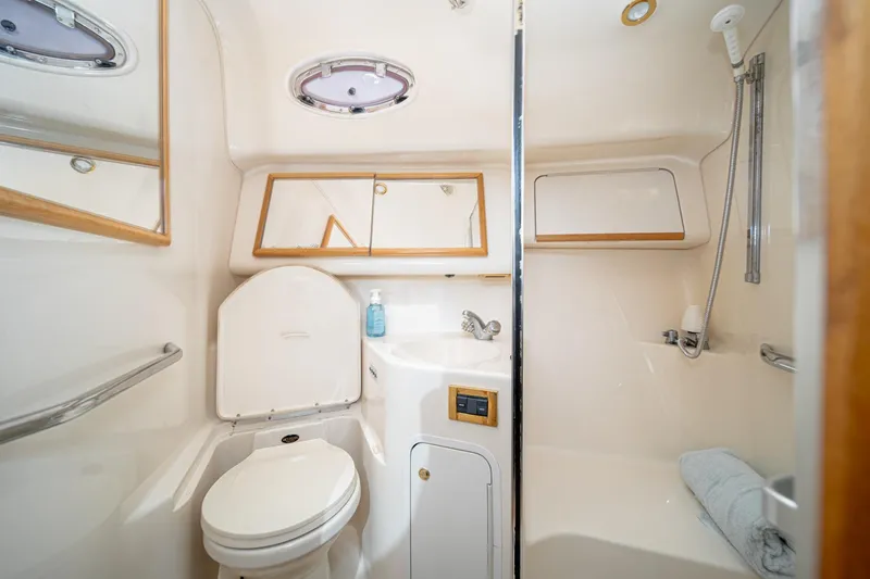 Slide: The Image of 1998 Sea Ray 420 Aft Cabin bathroom with toilet, sink, and shower. - 43