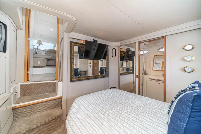 Slide: The Image of Luxurious 1998 Sea Ray 420 Aft Cabin interior with cozy bedroom and modern amenities. - 46