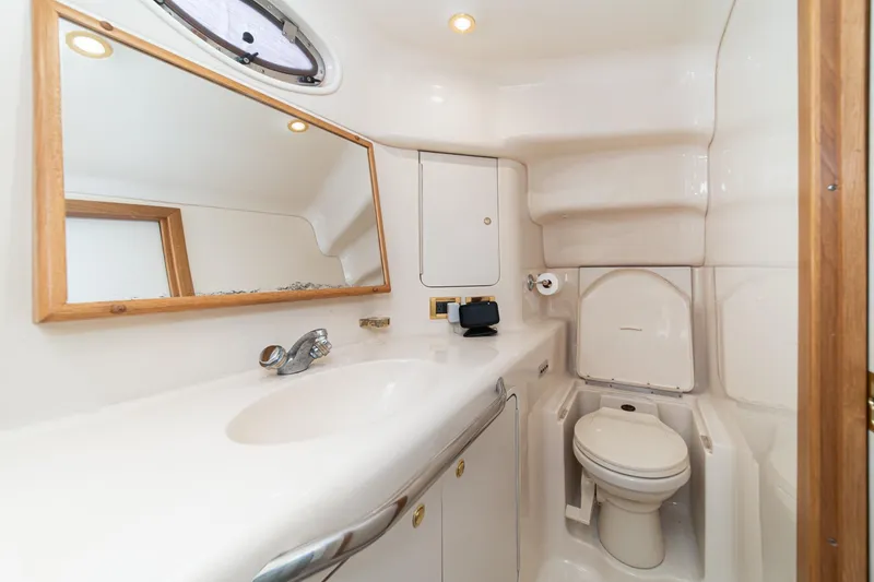 Slide: The Image of 1998 Sea Ray 420 Aft Cabin bathroom with sink, mirror, and toilet. - 48