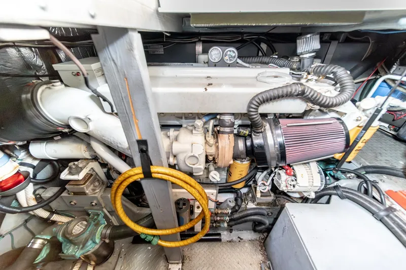 Slide: The Image of Engine room of a 1998 Sea Ray 420 Aft Cabin yacht, showcasing mechanical components. - 49