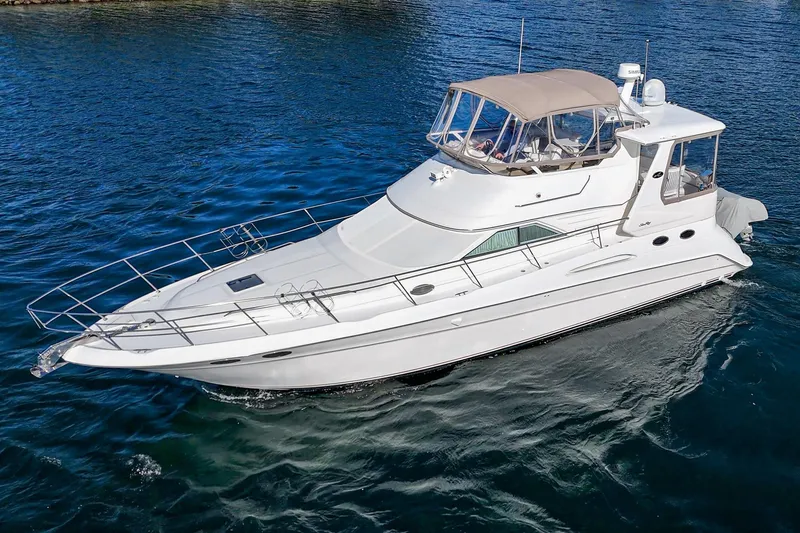 Slide: The Image of 1998 Sea Ray 420 Aft Cabin yacht cruising on blue water. - 7