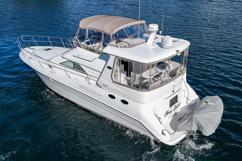 Slide: The Image of 1998 Sea Ray 420 Aft Cabin yacht cruising on blue water. - 9