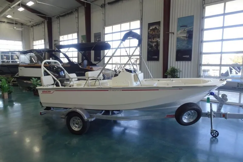 The Image of 2026 Boston Whaler 170 Montauk boat displayed indoors on a trailer. - 0