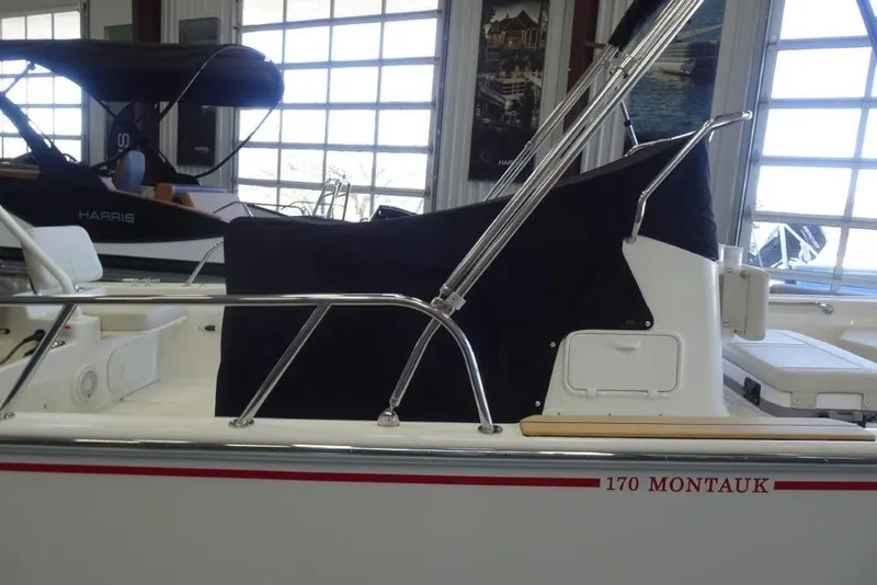 Slide: The Image of 2026 Boston Whaler 170 Montauk boat interior in showroom setting. - 15