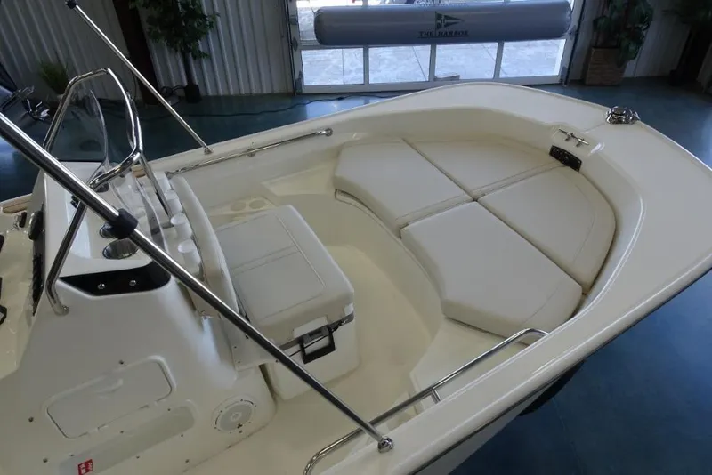 Slide: The Image of 2026 Boston Whaler 170 Montauk boat interior with cushioned seating and console. - 3