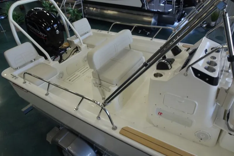 Slide: The Image of 2026 Boston Whaler 170 Montauk boat interior with seating and Mercury engine. - 4