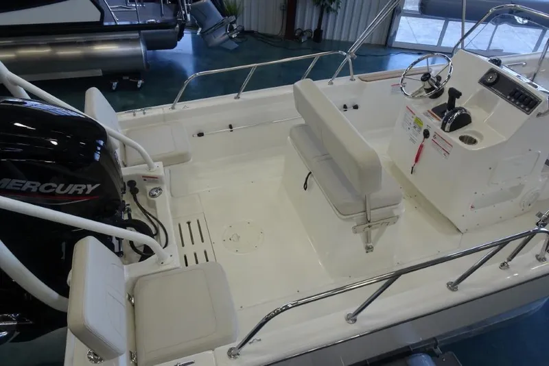 Slide: The Image of 2026 Boston Whaler 170 Montauk boat interior with Mercury engine and seating. - 6