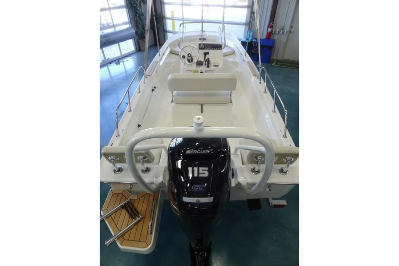 Slide: The Image of 2026 Boston Whaler 170 Montauk boat with Mercury 115 engine in showroom. - 7