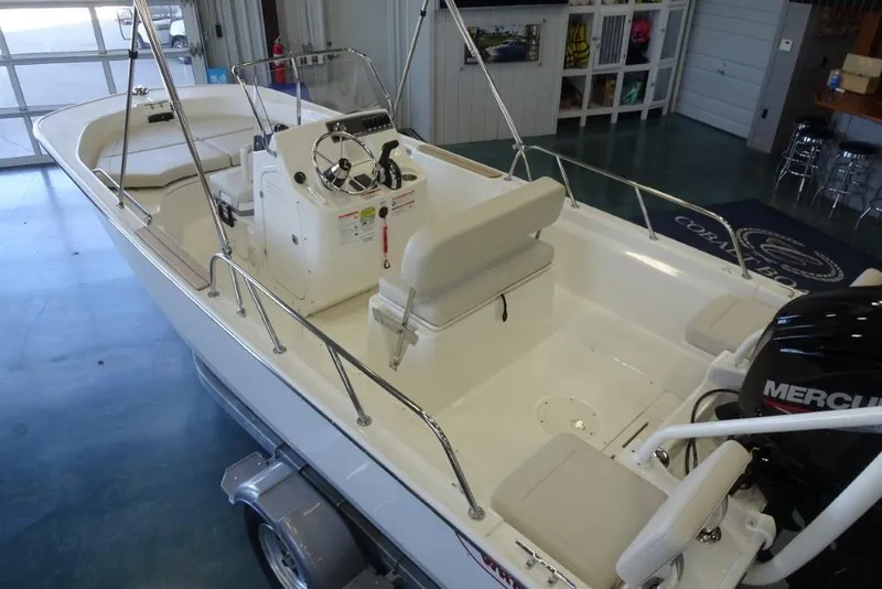 Slide: The Image of 2026 Boston Whaler 170 Montauk boat interior with steering console and seating. - 8