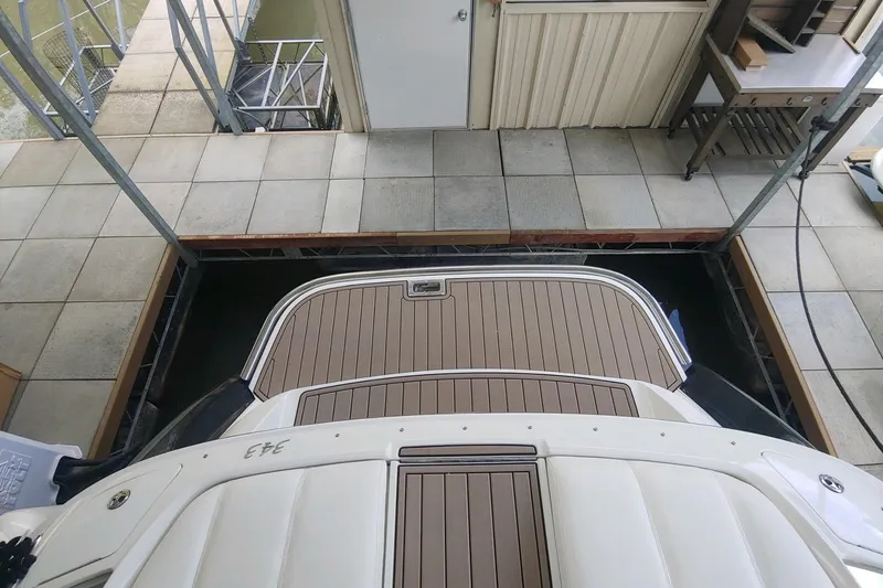 Slide: The Image of 2004 Cobalt 343 boat docked in a covered marina slip. - 11