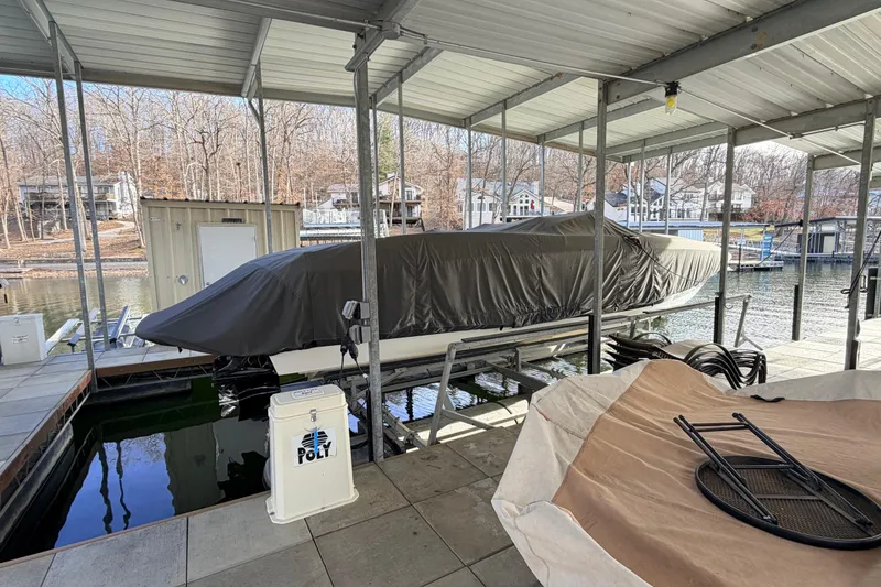 Slide: The Image of Covered 2004 Cobalt 343 boat docked in a sheltered marina area. - 12