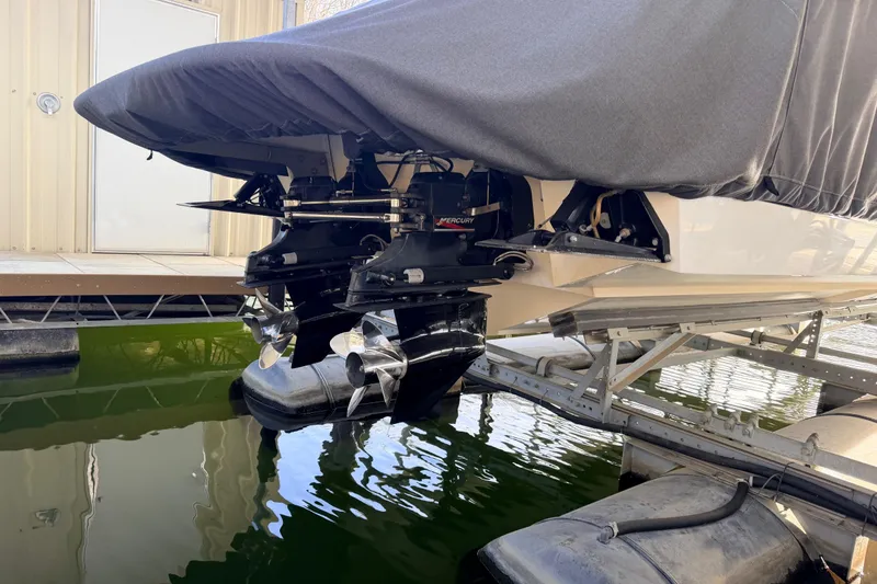 Slide: The Image of Covered 2004 Cobalt 343 boat with Mercury outboard engines on a lift. - 14