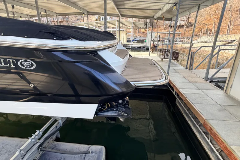 Slide: The Image of 2004 Cobalt 343 boat docked in a covered marina, rear view. - 18