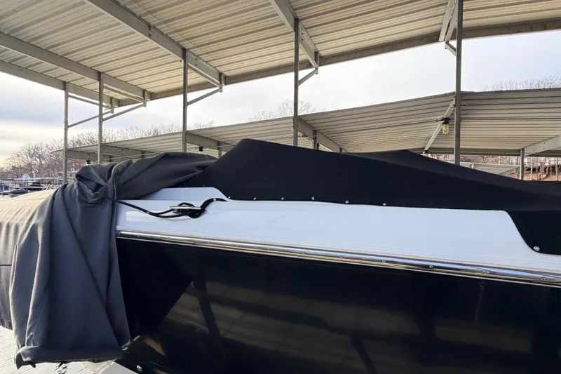 Slide: The Image of Covered 2004 Cobalt 343 boat under a metal canopy at a marina. - 20