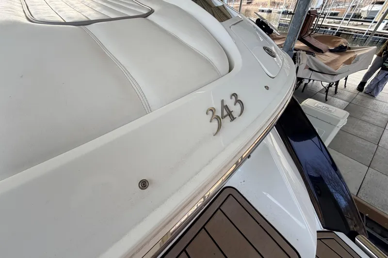 Slide: The Image of 2004 Cobalt 343 boat docked, showcasing sleek design and elegant detailing. - 27