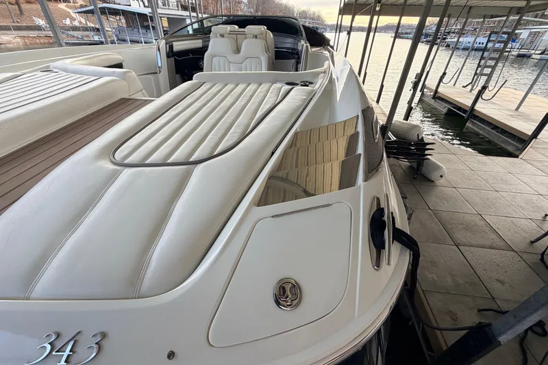 Slide: The Image of 2004 Cobalt 343 boat docked, featuring sleek white seating and elegant design. - 28