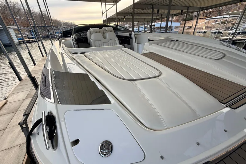 Slide: The Image of 2004 Cobalt 343 boat docked, featuring sleek white design and spacious seating. - 30